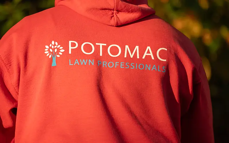 Close-up of Potomac Lawn Professionals branded red hoodie