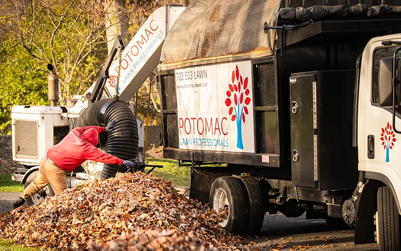 A Potomac Lawn Professionals work truck at a residential job site in Arlington, Virginia